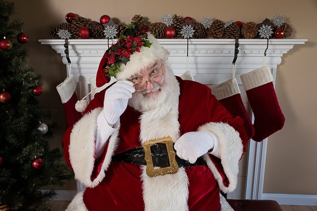 Santa Claus filling stockings furtively