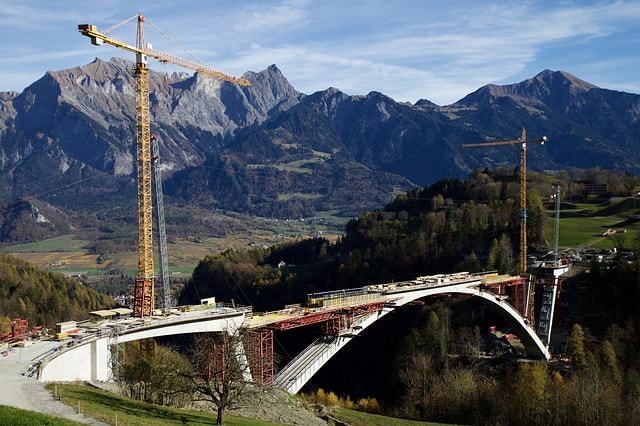 a bridge being built across a gorge