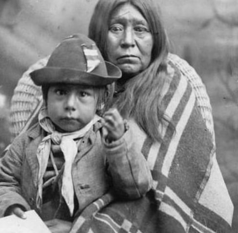 An Indian squaw pleading to the chief for the lives of her children